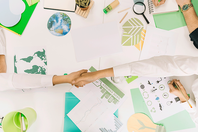 Estrechón de manos sobre documentos de certificación verde